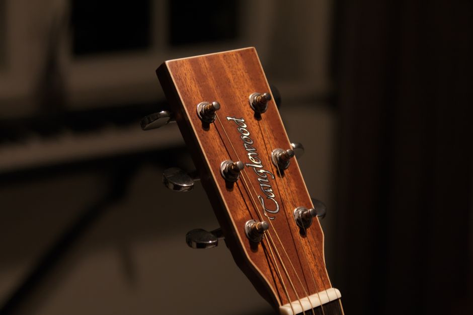 Close-up of an acoustic guitar headstock and tuning machines