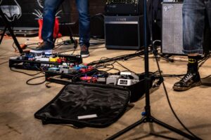 Close-up of guitar pedal boards and amps during live performance in Atlanta, Georgia.